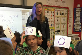 Woman teaching a class to students using SIOP techniques