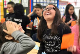 Students in a classroom smiling