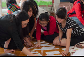 4 teachers working on the floor on an activity