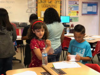 Two students performing activity in classroom setting