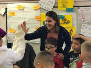 Teacher in classroom with students