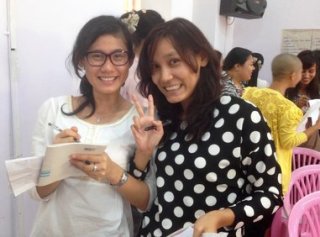 Two women smiling while posing for a photograph