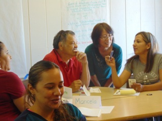 Adults having a conversation around a table